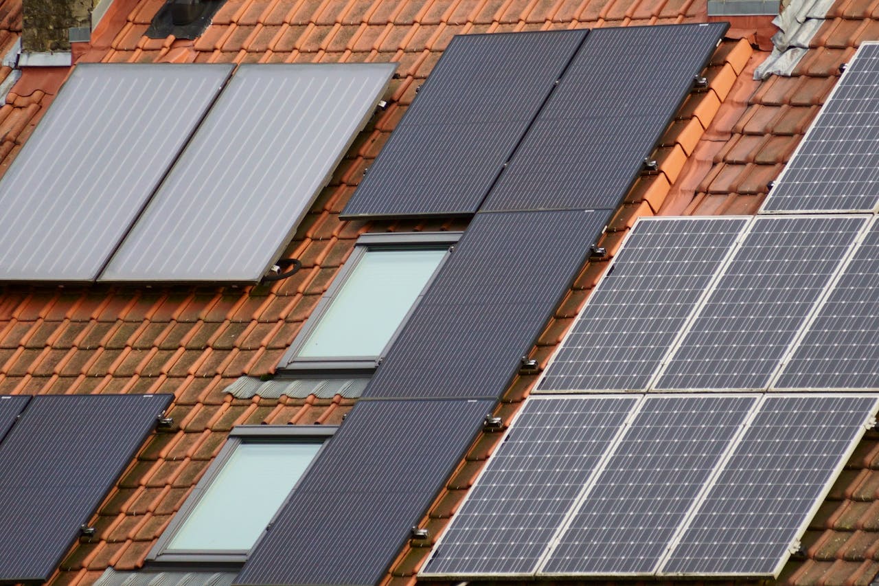 Close-up of solar panels on a tiled roof, showcasing sustainable energy solutions.